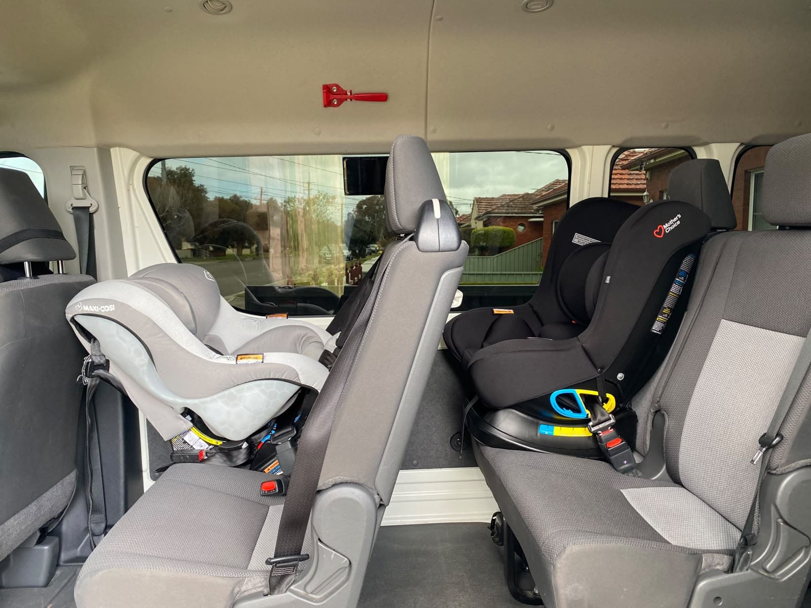 The cabin of our van, three rows of seats with two rear-facing baby seats already fitted before pickup